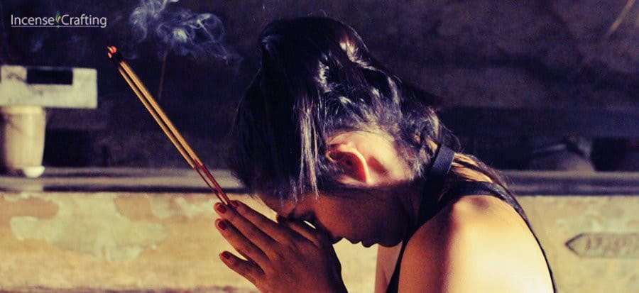 Praying with incense sticks during funeral
