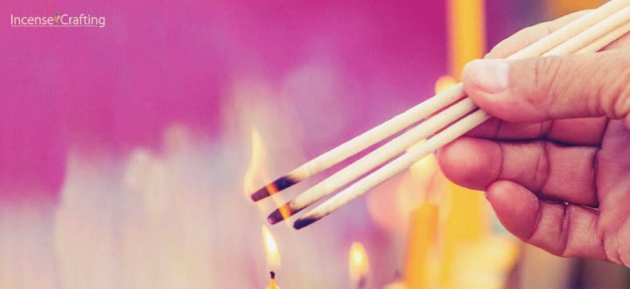 Burning three incense sticks for good luck